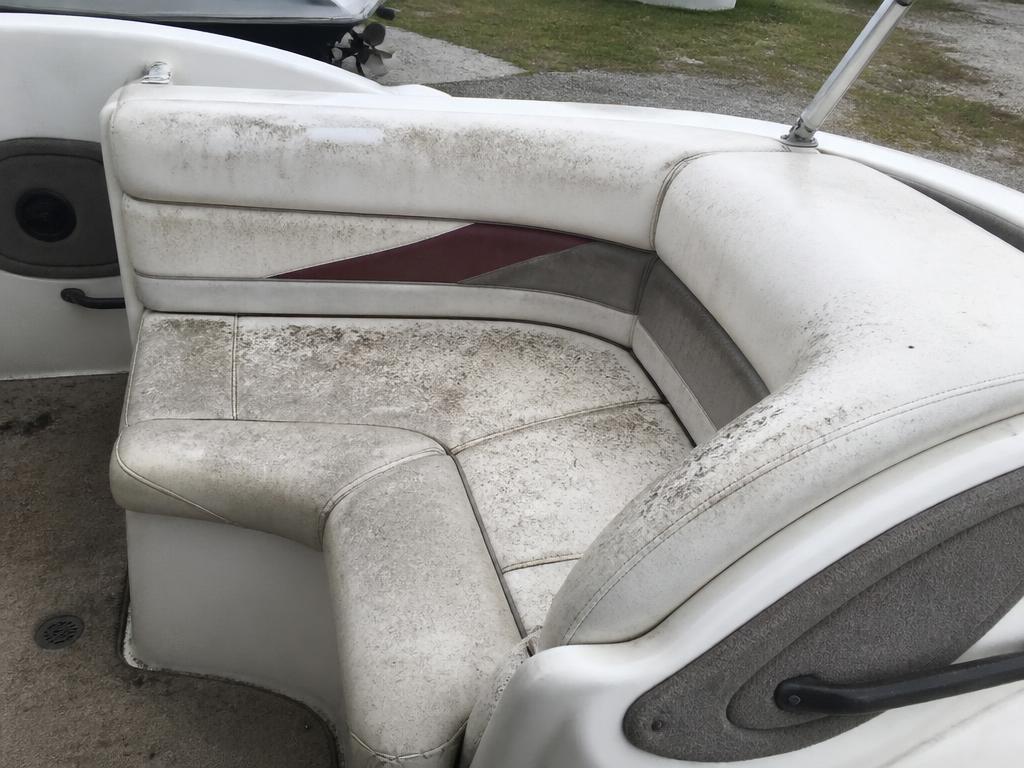 Stained boat cockpit vinyl seating before cleaning